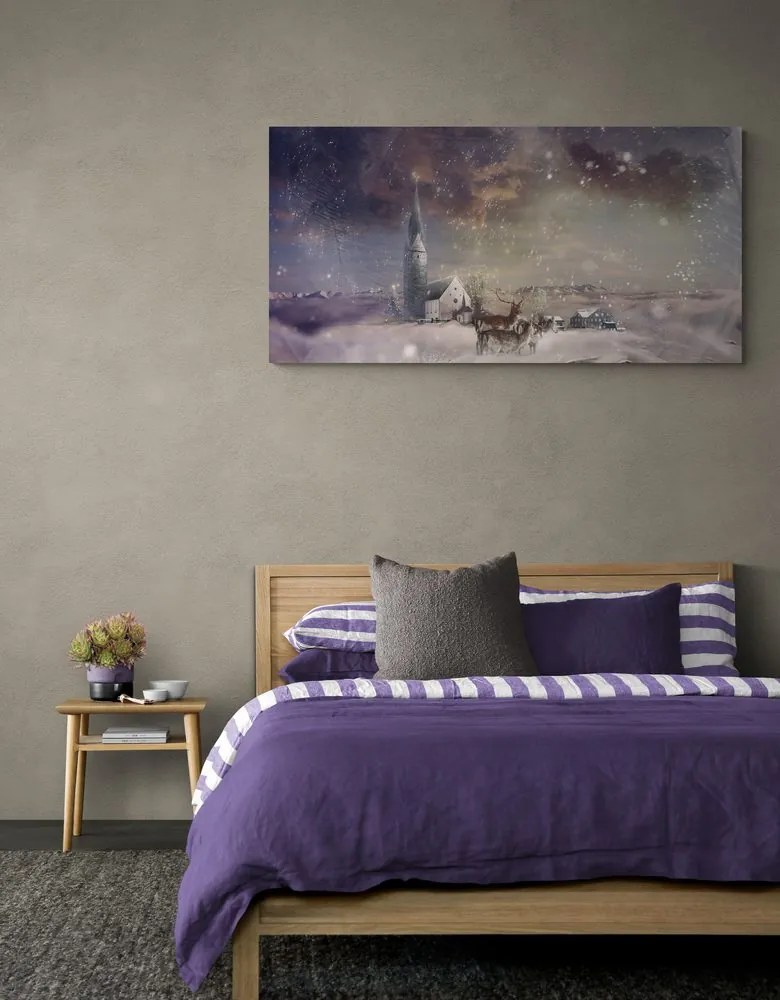 Quadro su tela – Cervo e caprioli nel villaggio innevato