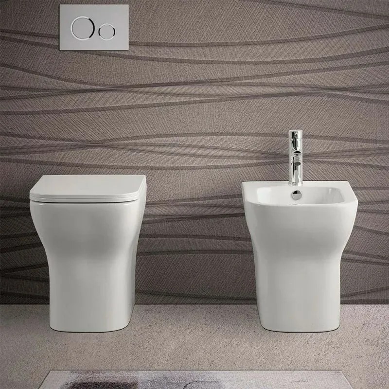 Wc filomuro bianco lucido senza brida con scarico multiplo Plana