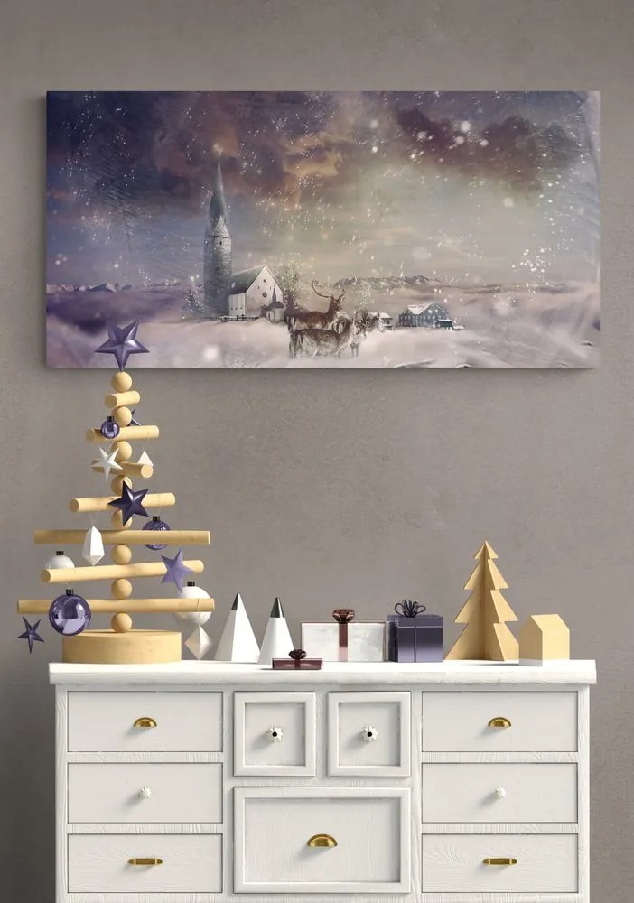 Quadro su tela – Cervo e caprioli nel villaggio innevato