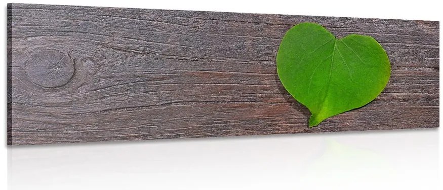 Stampa su tela – Foglia a forma di cuore su sfondo di legno