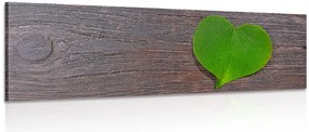 Stampa su tela – Foglia a forma di cuore su sfondo di legno